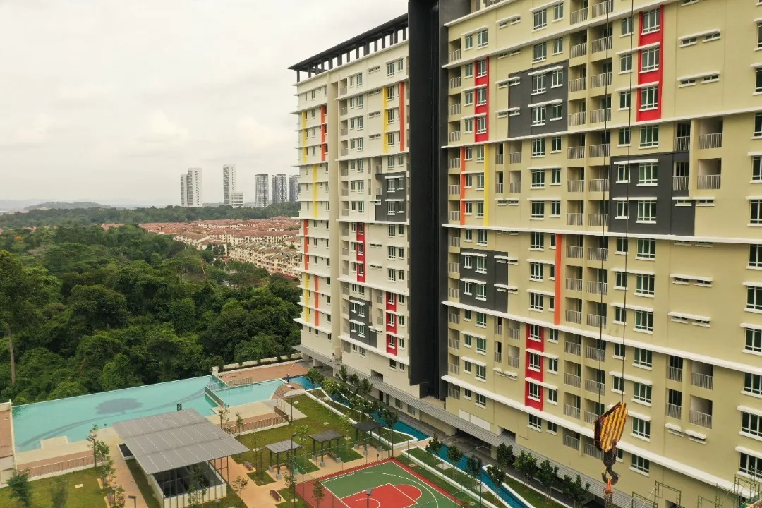 Alpinia Residence Image shows the building exterior with a swimming pool in the foreground. in Nilai, Freehold property development, photo