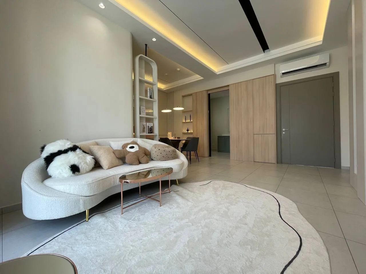 Alton Skyvillas Image shows the interior of a living room with a sofa, rug, and dining area in the background. in Jelutong, Freehold property development, photo