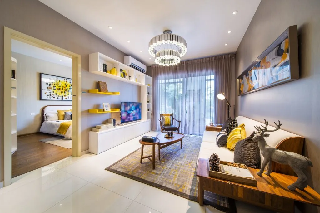  Country Garden Central Park This image shows the interior of a living room with a view into a bedroom. The living room has a sofa, coffee table, TV, and decorative shelves. in Johor Bahru, Freehold property development, render