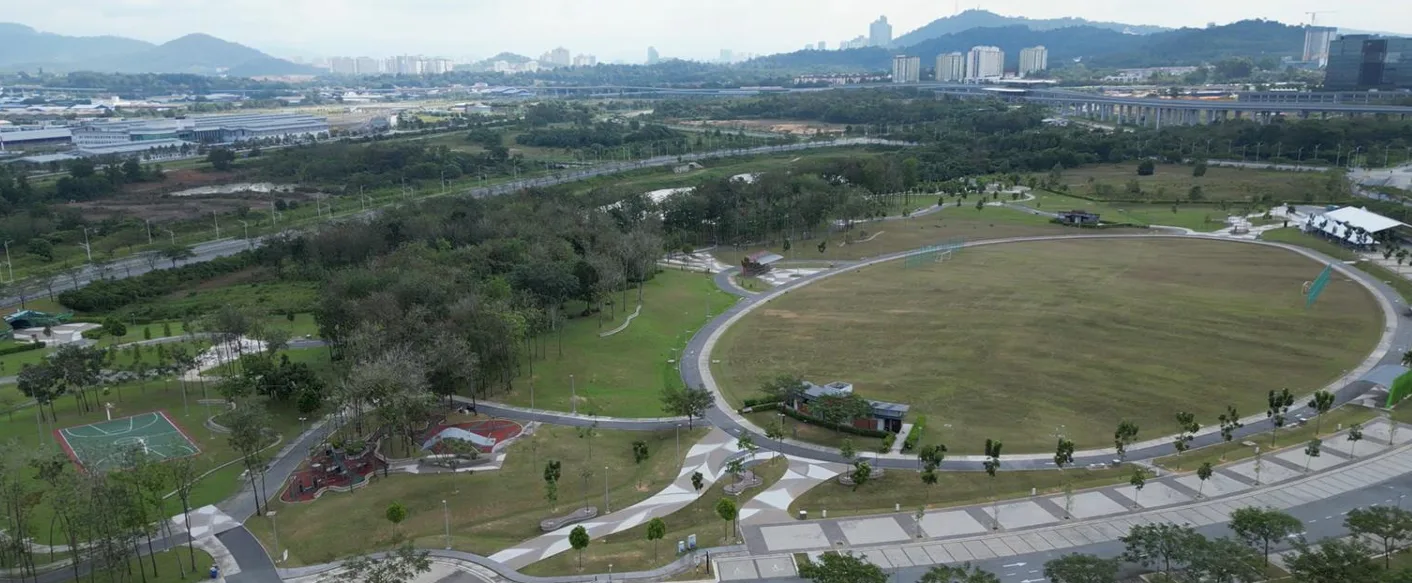 Daya Residence Aerial view of a large park with walking paths, green spaces, and a view of the city skyline in the background. in Shah Alam, Freehold property development, photo