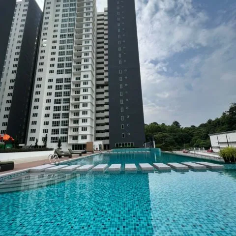 Emerald Residence The image shows the exterior of Emerald Residence with a swimming pool in the foreground. in Teluk Kumbar, Freehold property development, photo