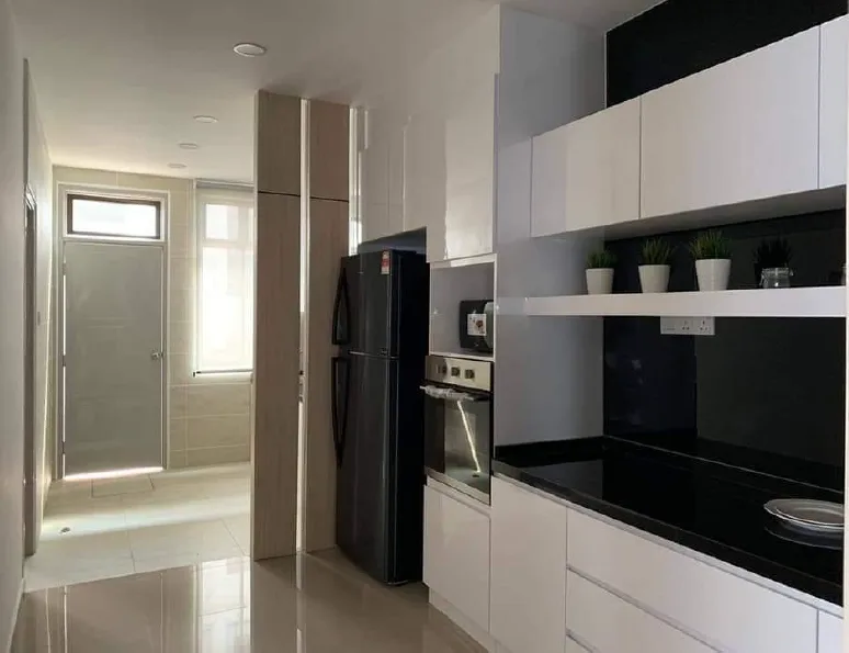 Taman Bestari Indah - KSL Lily The image shows the kitchen interior with white cabinets, black countertops, a refrigerator, and a view into another room., Freehold property development, photo