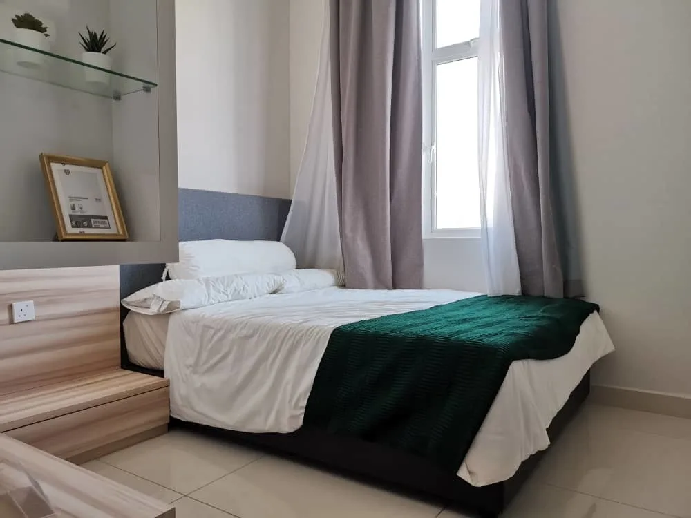 KSL Mutiara Bestari Taman Nusa Bestari Image shows a bedroom interior with a bed, window, curtains, built-in shelves, and a desk with a chair. in Skudai, Freehold property development, photo