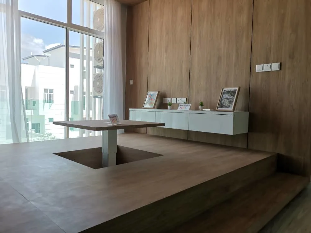 KSL Mutiara Bestari Taman Nusa Bestari Interior shot of a lounge area with a unique table design and a view of the building exterior through large windows. in Skudai, Freehold property development, photo