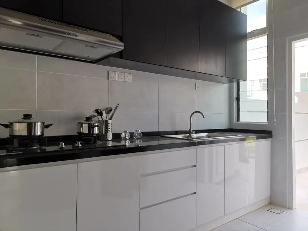 KSL Mutiara Bestari Taman Nusa Bestari A modern kitchen with white cabinets, black countertops, and stainless steel appliances. in Skudai, Freehold property development, photo