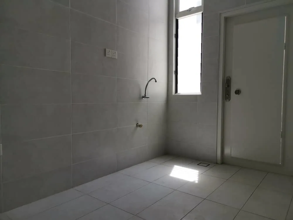 KSL Mutiara Bestari Taman Nusa Bestari The image shows a utility area with tiled walls and floor, a faucet, a window, and a door. in Skudai, Freehold property development, photo