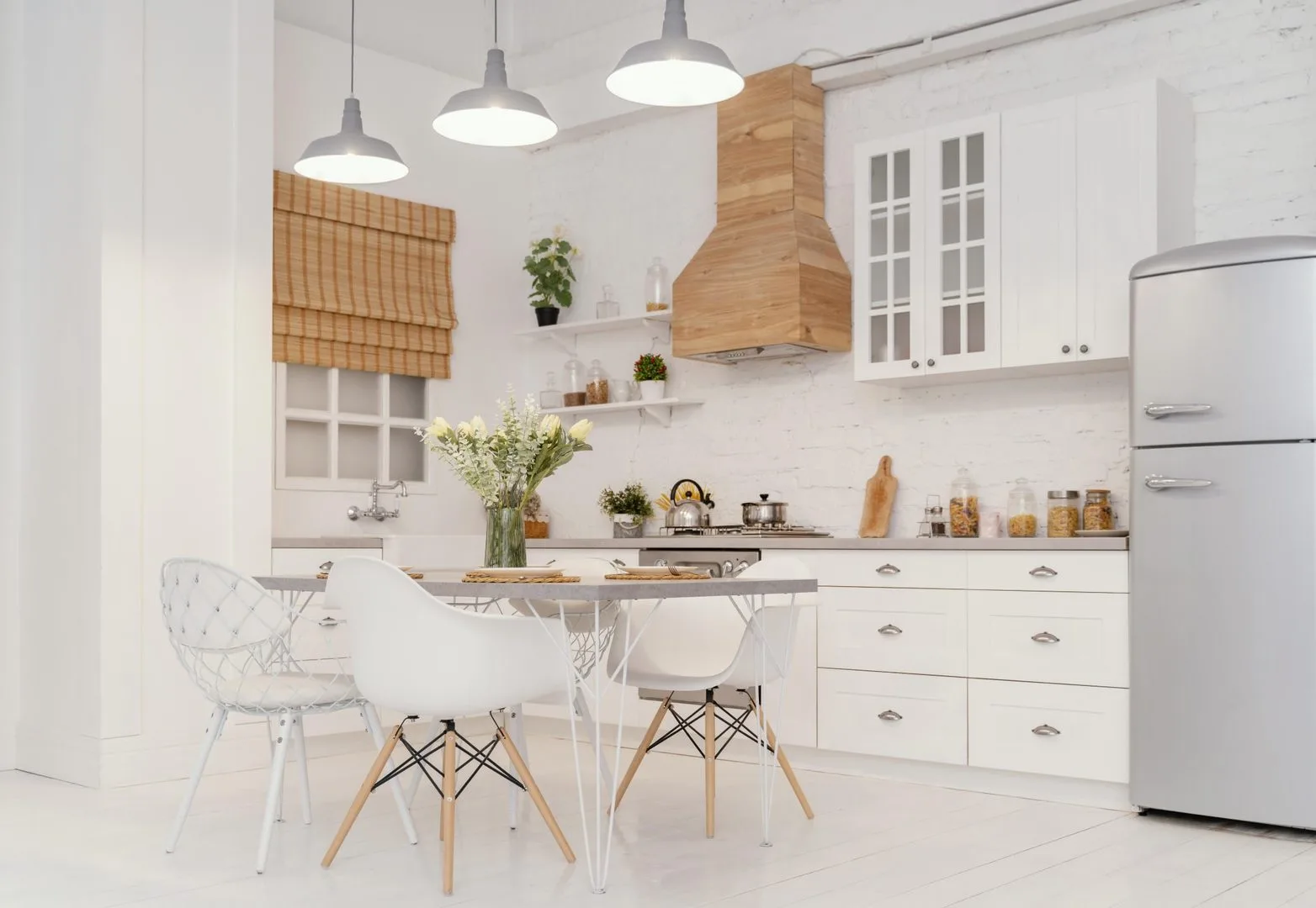 Livista Bandar Sri Damansara A bright, modern kitchen with white cabinets, a wooden range hood, a dining table with chairs, and a silver refrigerator. in Bandar Sri Damansara, Freehold property development, photo