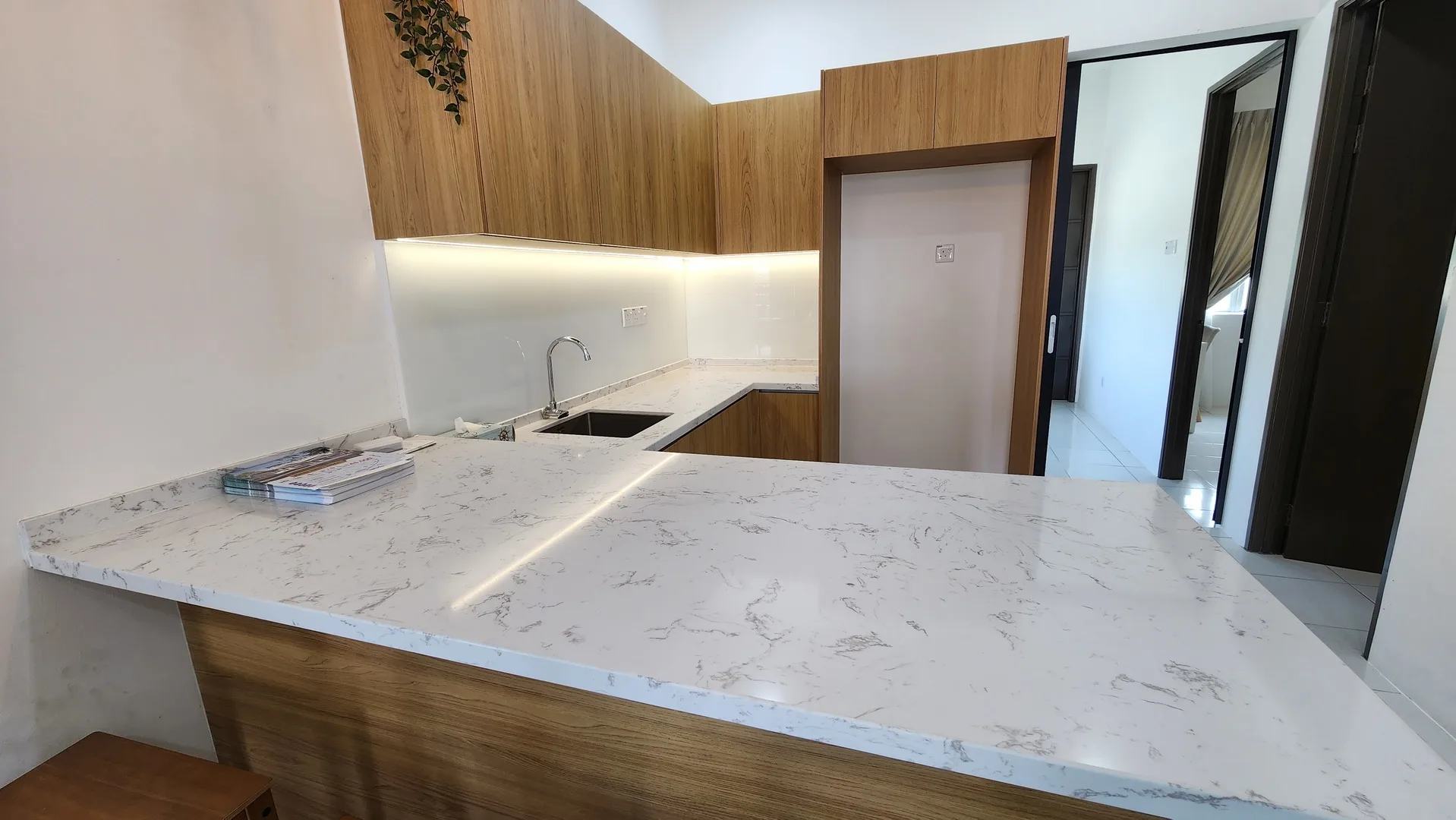Perwira Seri Iskandar Image shows a kitchen counter with a sink and wooden cabinets. in Seri Iskandar, Freehold property development, photo