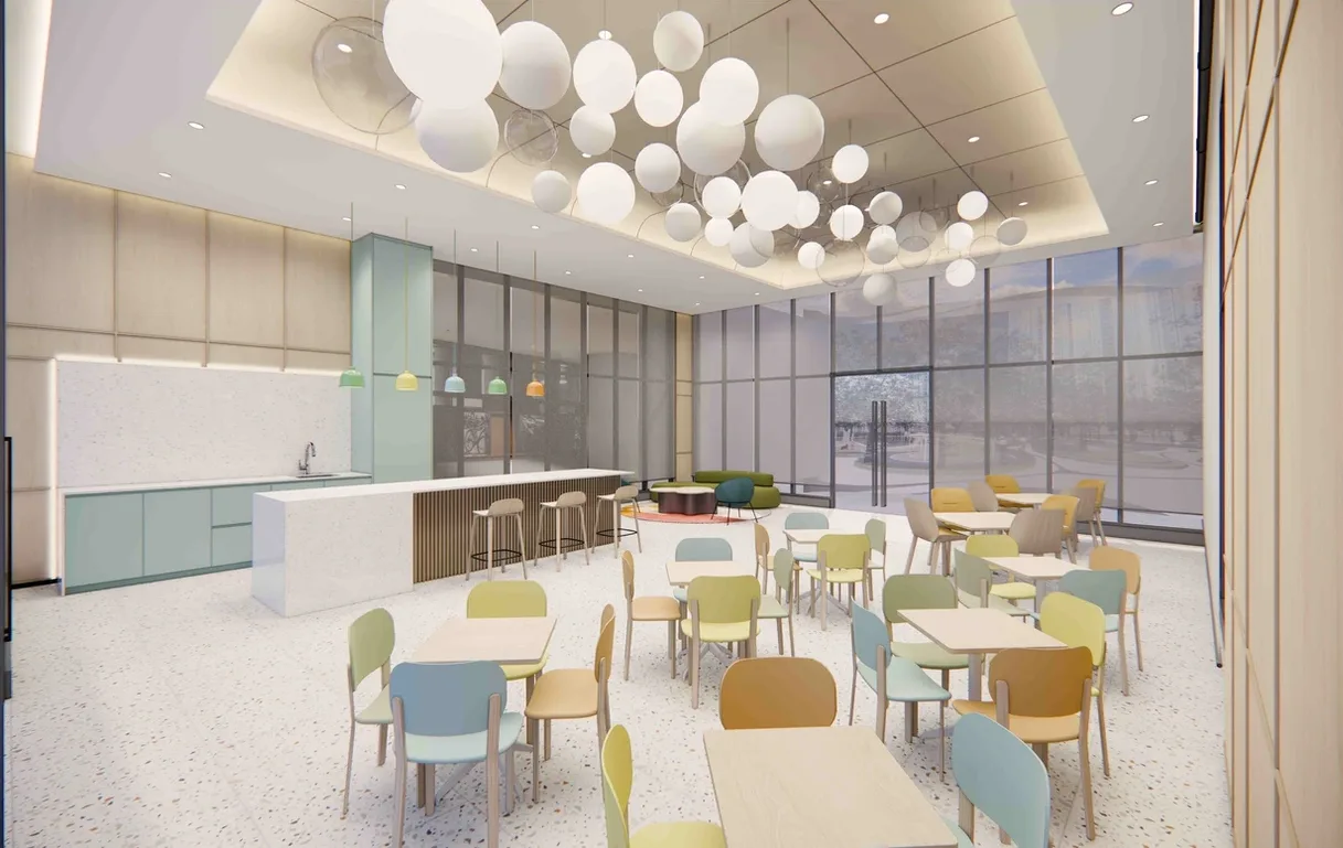 REN Residence Image shows a render of a co-working space with tables, chairs, a kitchen area, and large windows. in Bukit Jalil, Leasehold property development, render